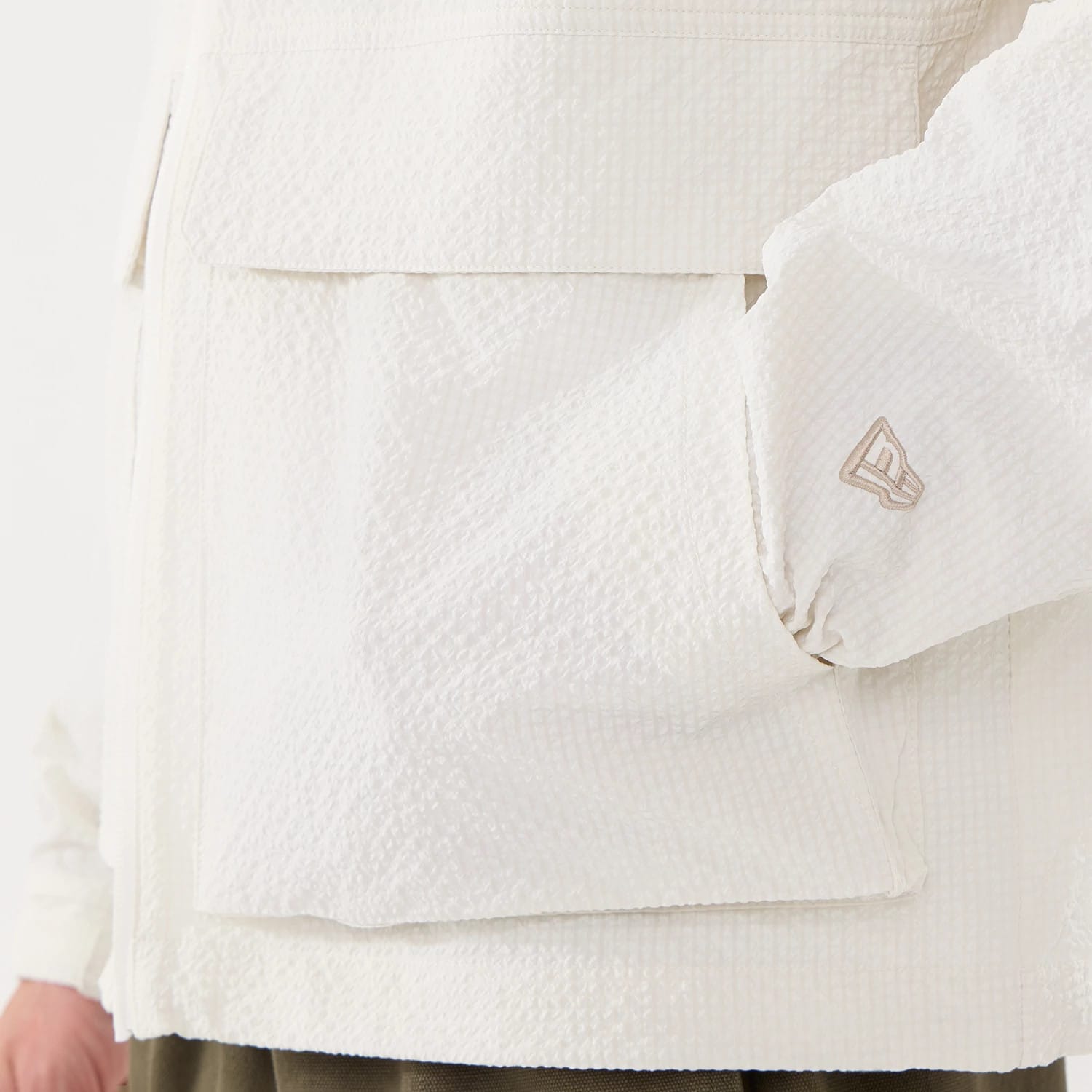 The model is wearing this New Era Black Label Jacket in open white. 5