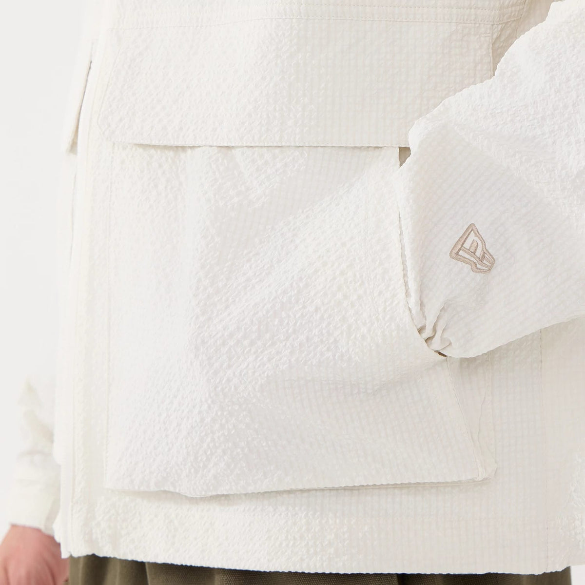 The model is wearing this New Era Black Label Jacket in open white. 5