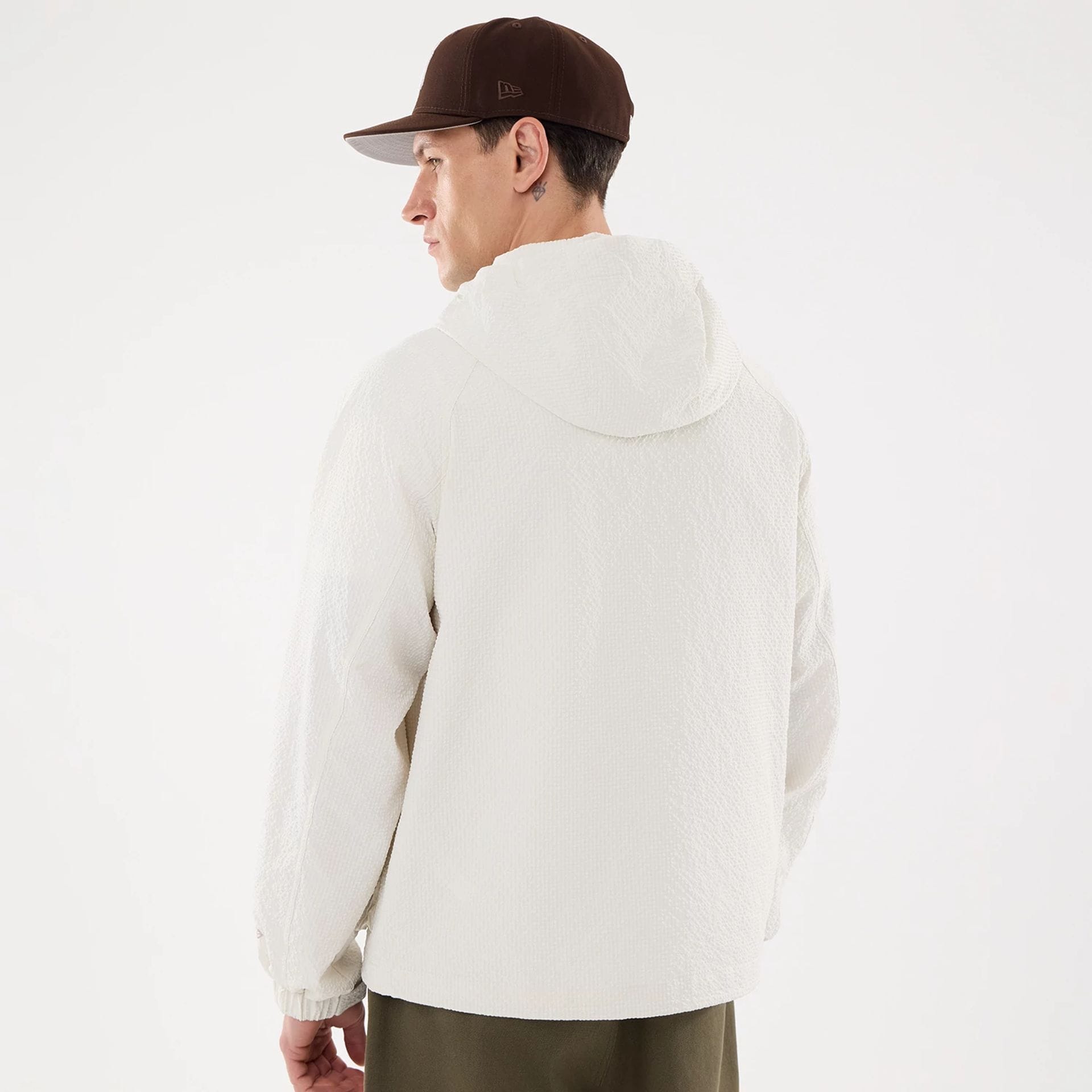 The model is wearing this New Era Black Label Jacket in open white. 2