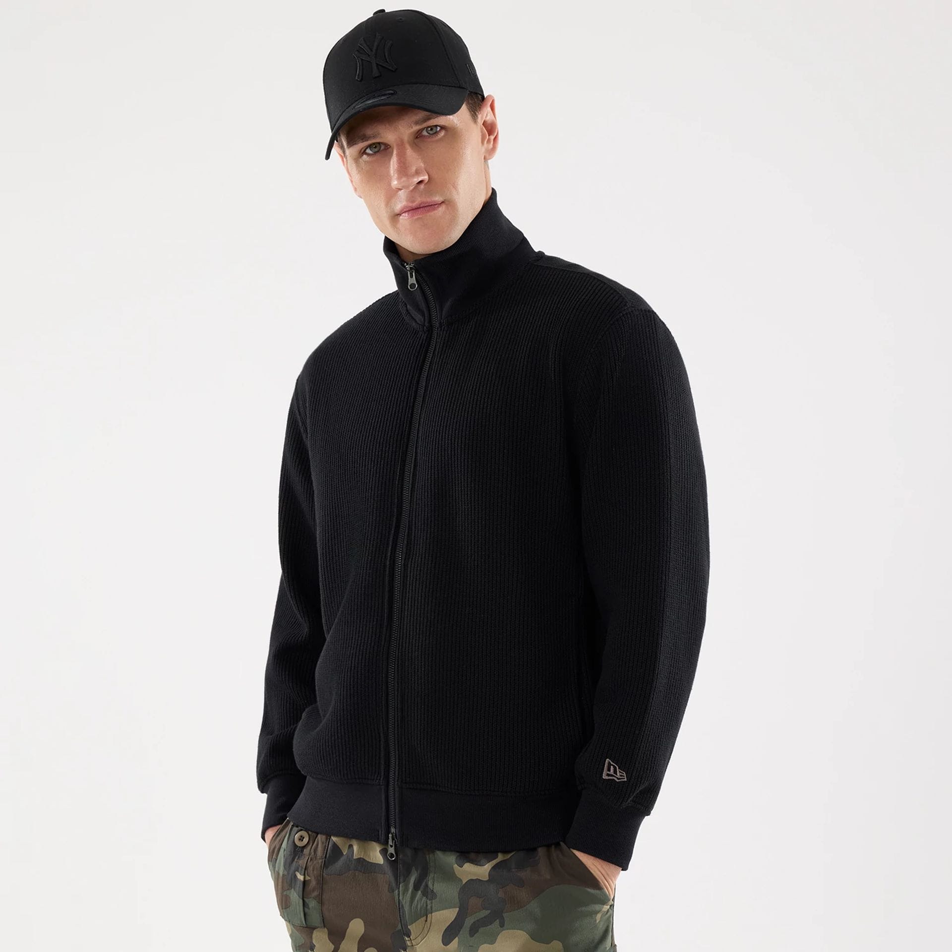 The model is wearing this New Era Black Label Jacket in black. 1