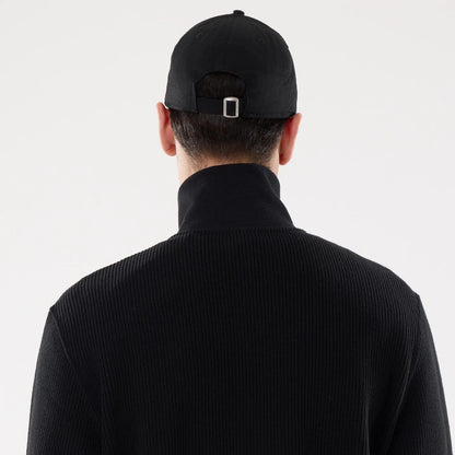 The model is wearing this New Era Black Label Jacket in black. 7