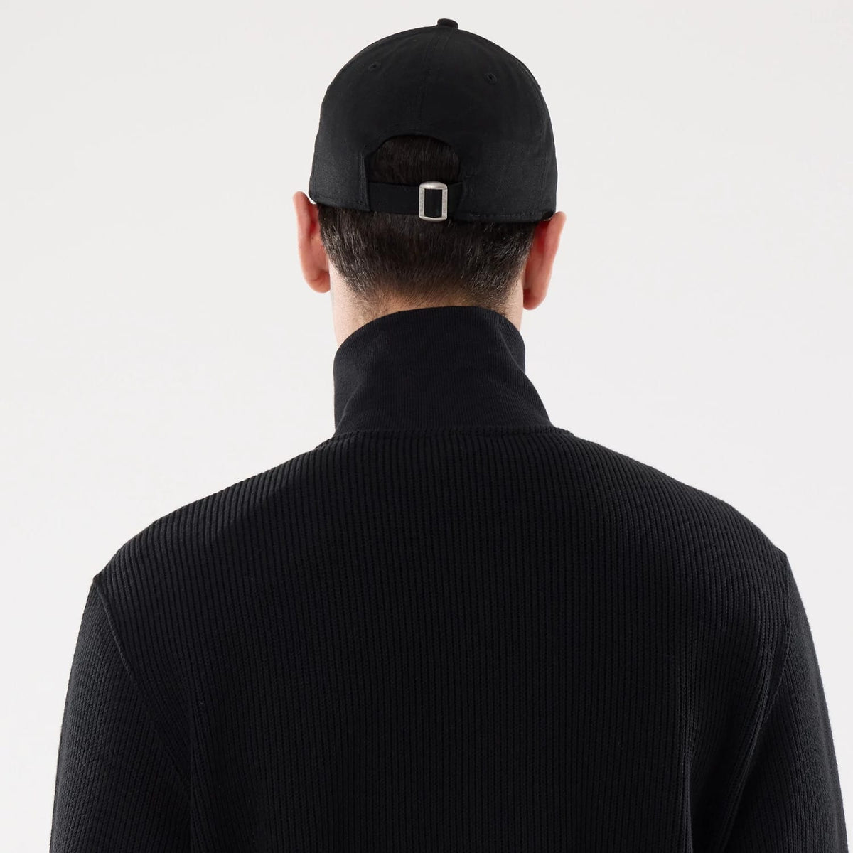 The model is wearing this New Era Black Label Jacket in black. 7