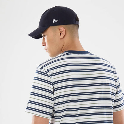 The model is wearing this New Era Boarder Stripe T-Shirt in white. 5