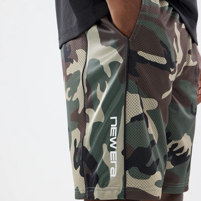 The model is wearing this New Era Bermuda Oversized Shorts in 6 Day Camo. 3