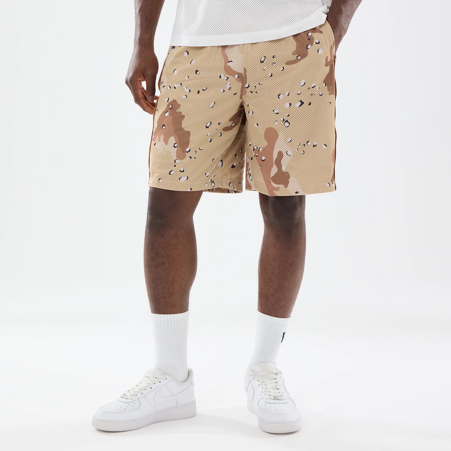 The model is wearing this New Era Bermuda Oversized Shorts in Woodland Camo. 1