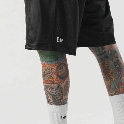 The model is wearing this New Era Bermuda Oversized Shorts in black. 3