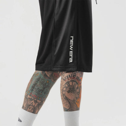 The model is wearing this New Era Bermuda Oversized Shorts in black. 4