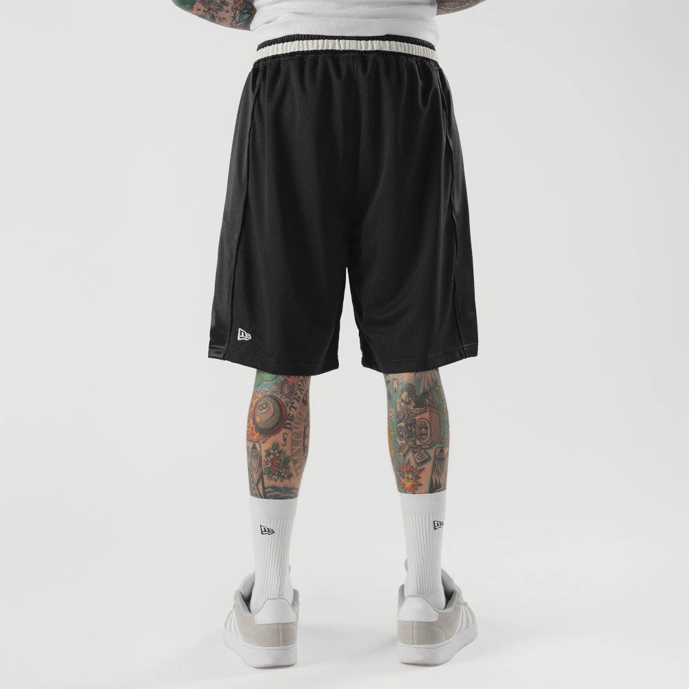 The model is wearing this New Era Bermuda Oversized Shorts in black. 2