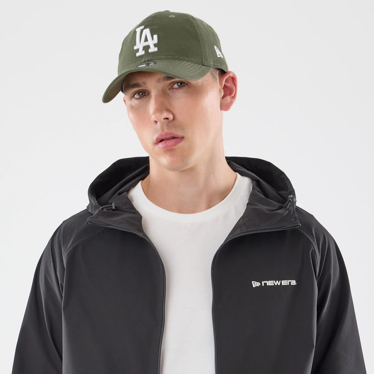 The model is wearing this New Era Windbreaker Jacket in black. 5