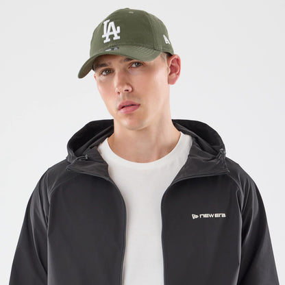 The model is wearing this New Era Windbreaker Jacket in black. 5
