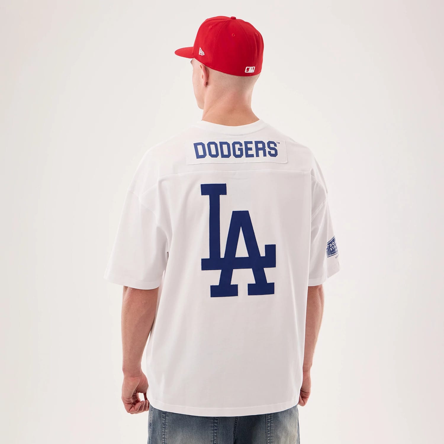 The model is wearing this MLB Fan Family Los Angeles Dodgers Jersey in white. 2
