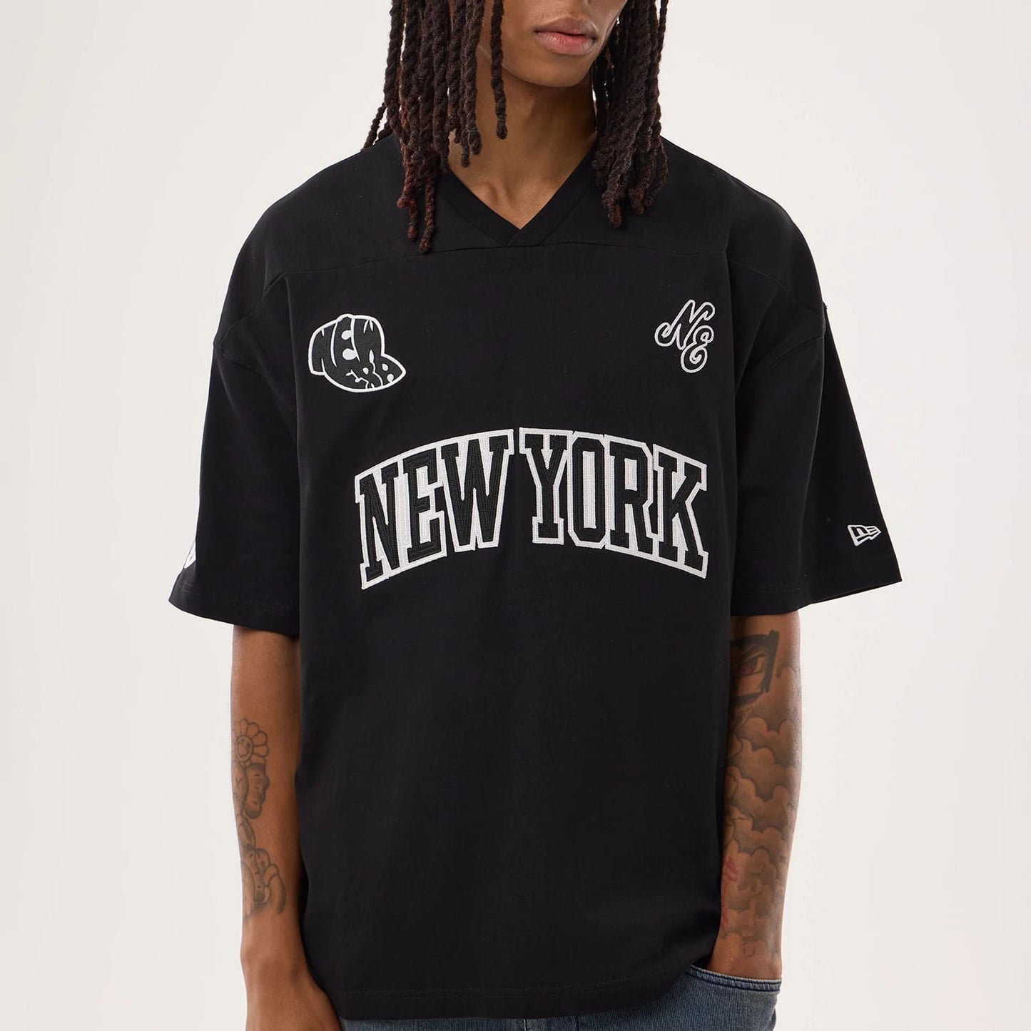 The model is wearing this New Era Fan Family Jersey in black. 3