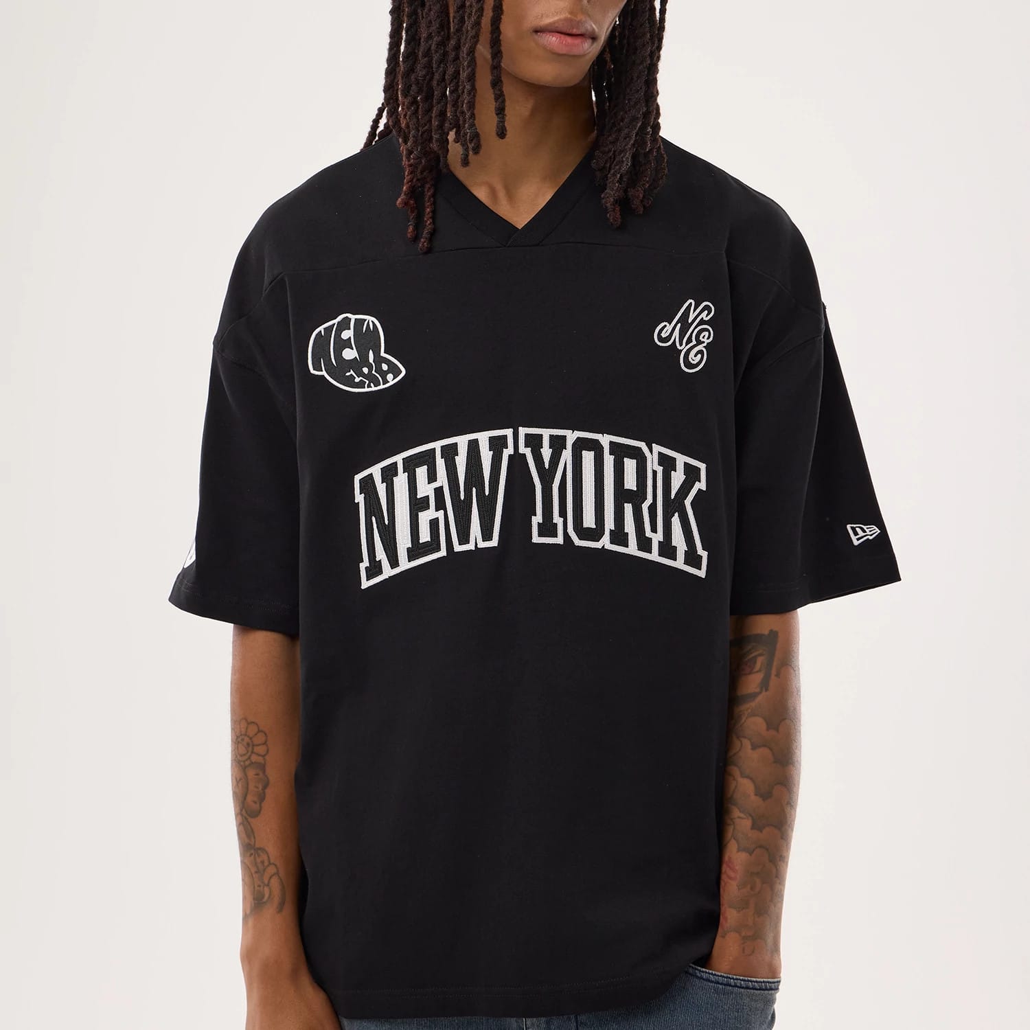 The model is wearing this New Era Fan Family Jersey in black. 3