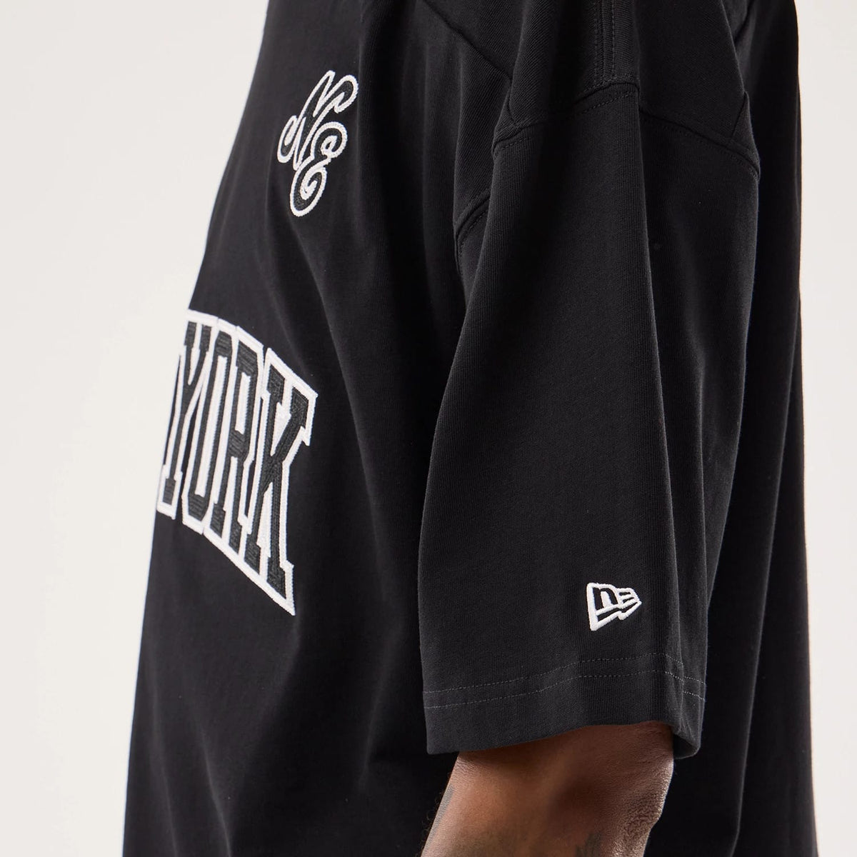 The model is wearing this New Era Fan Family Jersey in black. 5