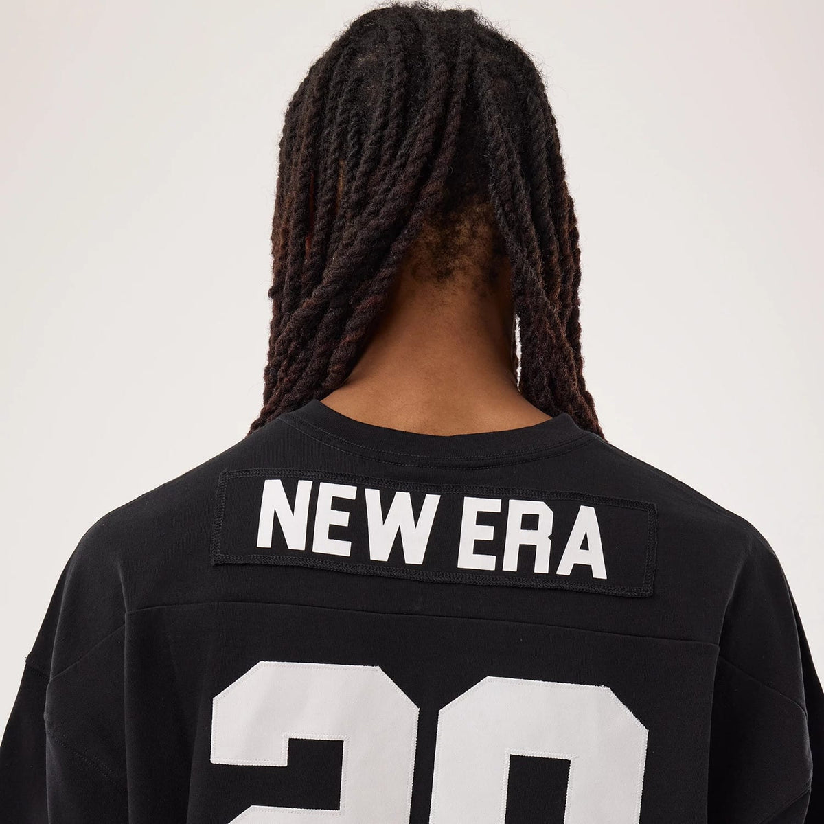 The model is wearing this New Era Fan Family Jersey in black. 7