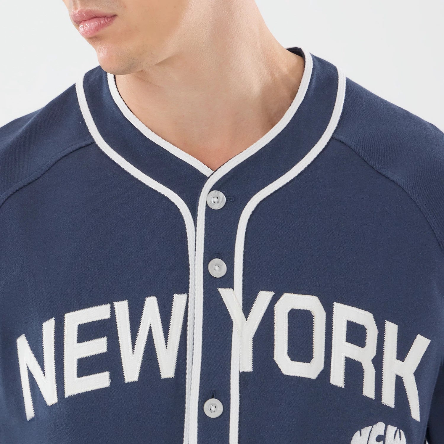 The model is wearing this New Era New York Jersey in navy. 4