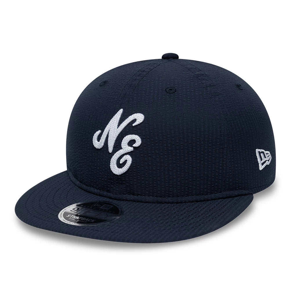 Pictured is this New Era Seersucker Retro Crown 9FIFTY cap in navy. 1