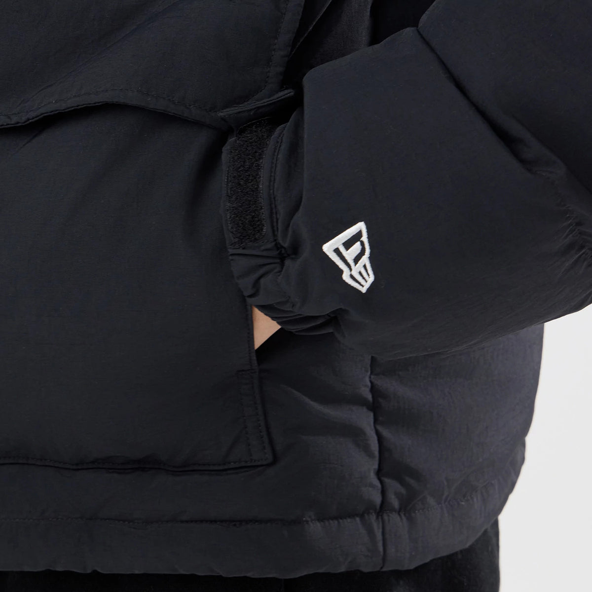The model is wearing this New Era Down Jacket in black. 4