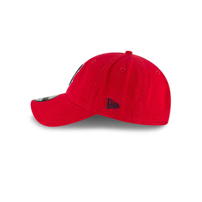 Boston Red Sox MLB Core Classic Red New Era 9TWENTY Adjustable Cap, side view showing the embroidered New Era flag logo on the left side of the unstructured crown and a curved visor with a 9TWENTY size sticker.