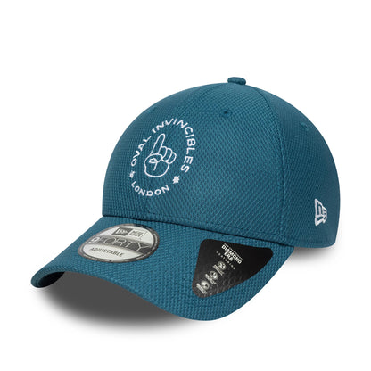Oval Invincibles The Hundred 2025 Blue New Era 9FORTY Adjustable Cap, three-quarter view showing a white embroidered logo on the front panel, New Era flag logo on the left side, and a 9FORTY size sticker on the visor.