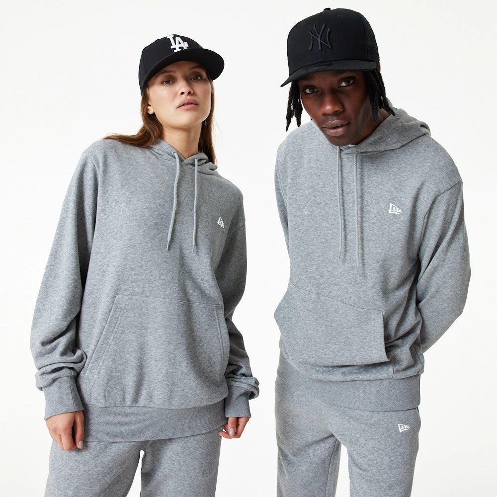 New Era Essential Grey Pullover Hoodie, on-model view showing two models wearing grey hoodies with long sleeves and front pockets, a debossed New Era logo on the chest, both styled with black caps.