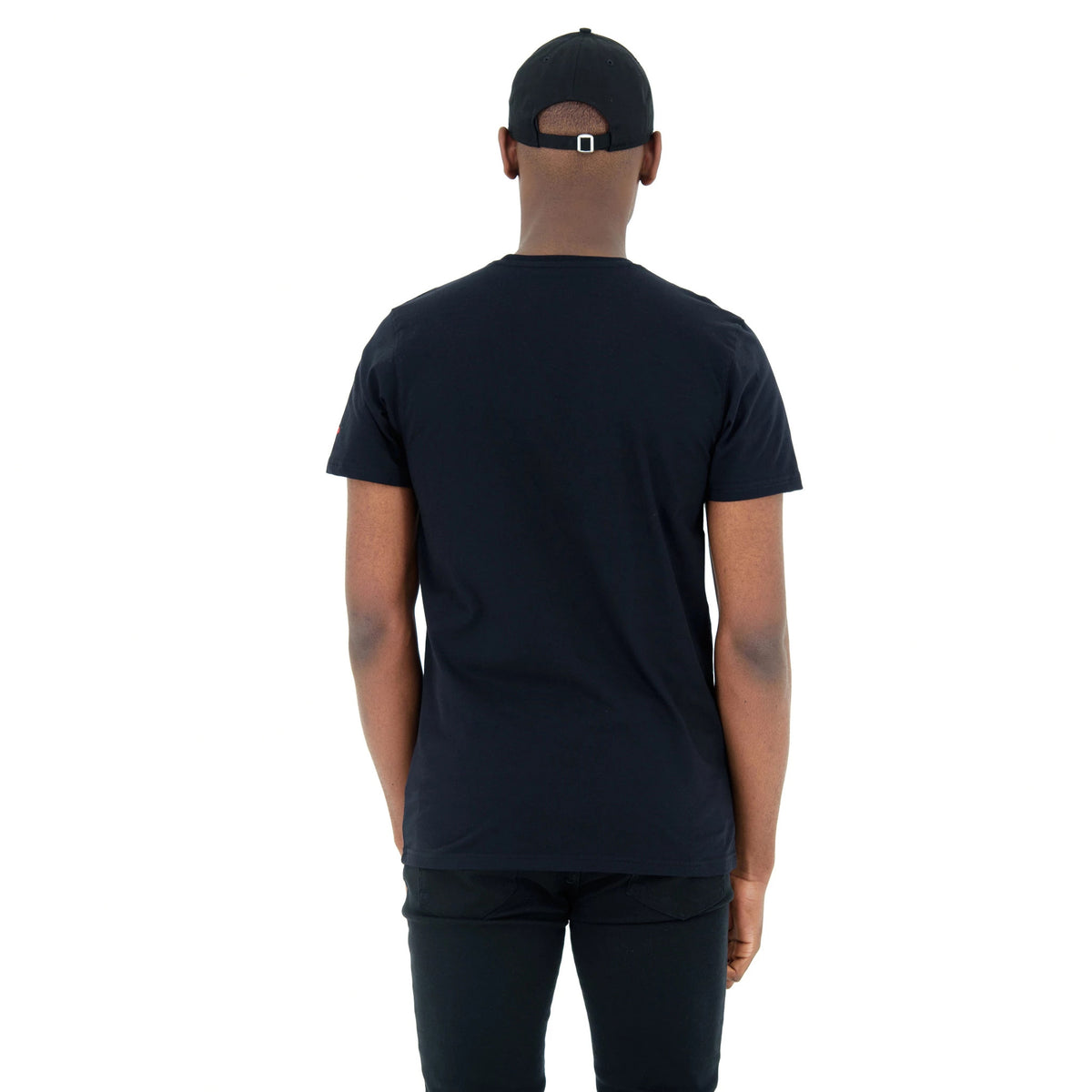 Chicago Bulls NBA Regular Black T-Shirt, rear view showing the plain black fabric with short sleeves, worn by a person also wearing a black cap with a metal buckle closure at the back.