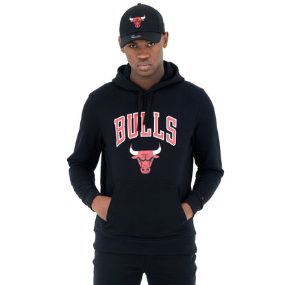Chicago Bulls NBA Regular Black Pullover Hoodie, on-model view showing the red and white Bulls logo and lettering on the chest, with a man wearing a black cap featuring a raised red Bull logo.
