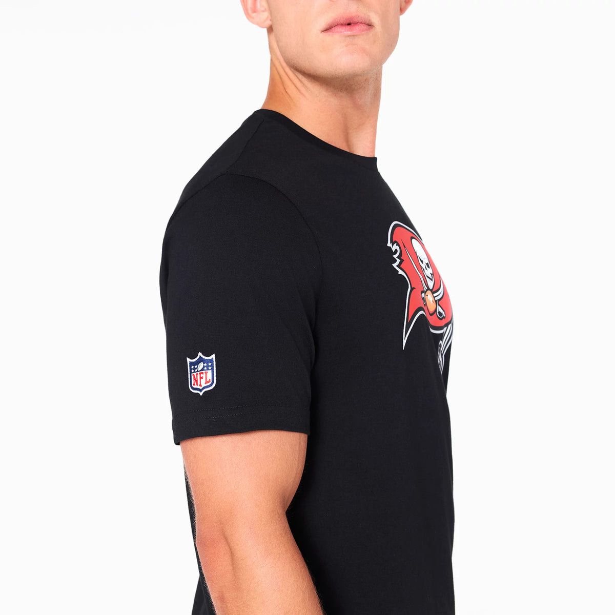 Tampa Bay Buccaneers NFL Black T-Shirt, on-model side view showing a large red and white Buccaneers logo printed on the chest and the embroidered NFL logo patch on the left sleeve.