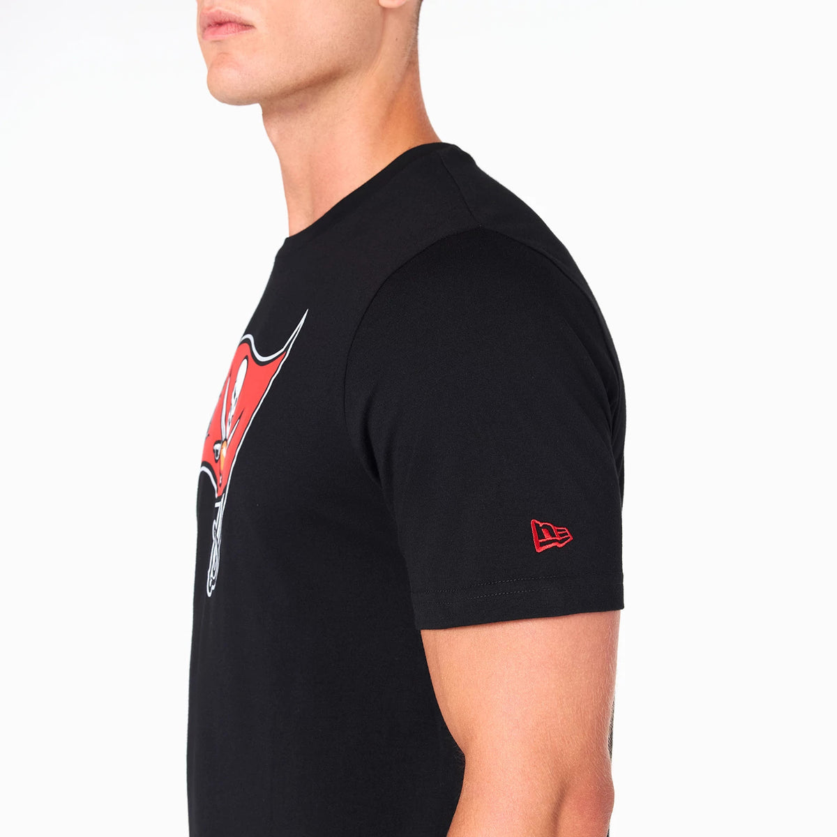 New Era Tampa Bay Buccaneers NFL Black T-Shirt, side view showing the short sleeve with a raised red New Era logo near the cuff, and a large red and white Buccaneers logo on the chest.