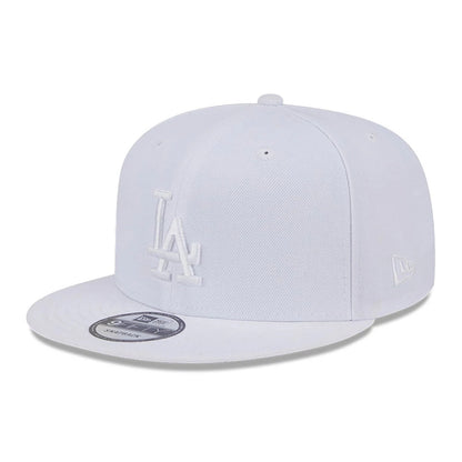 LA Dodgers MLB Evergreen White New Era 9FIFTY Snapback Adjustable Cap, three-quarter view showing the raised white LA logo on the front panel, the white New Era flag logo on the left side, and the 9FIFTY size sticker on the flat visor.