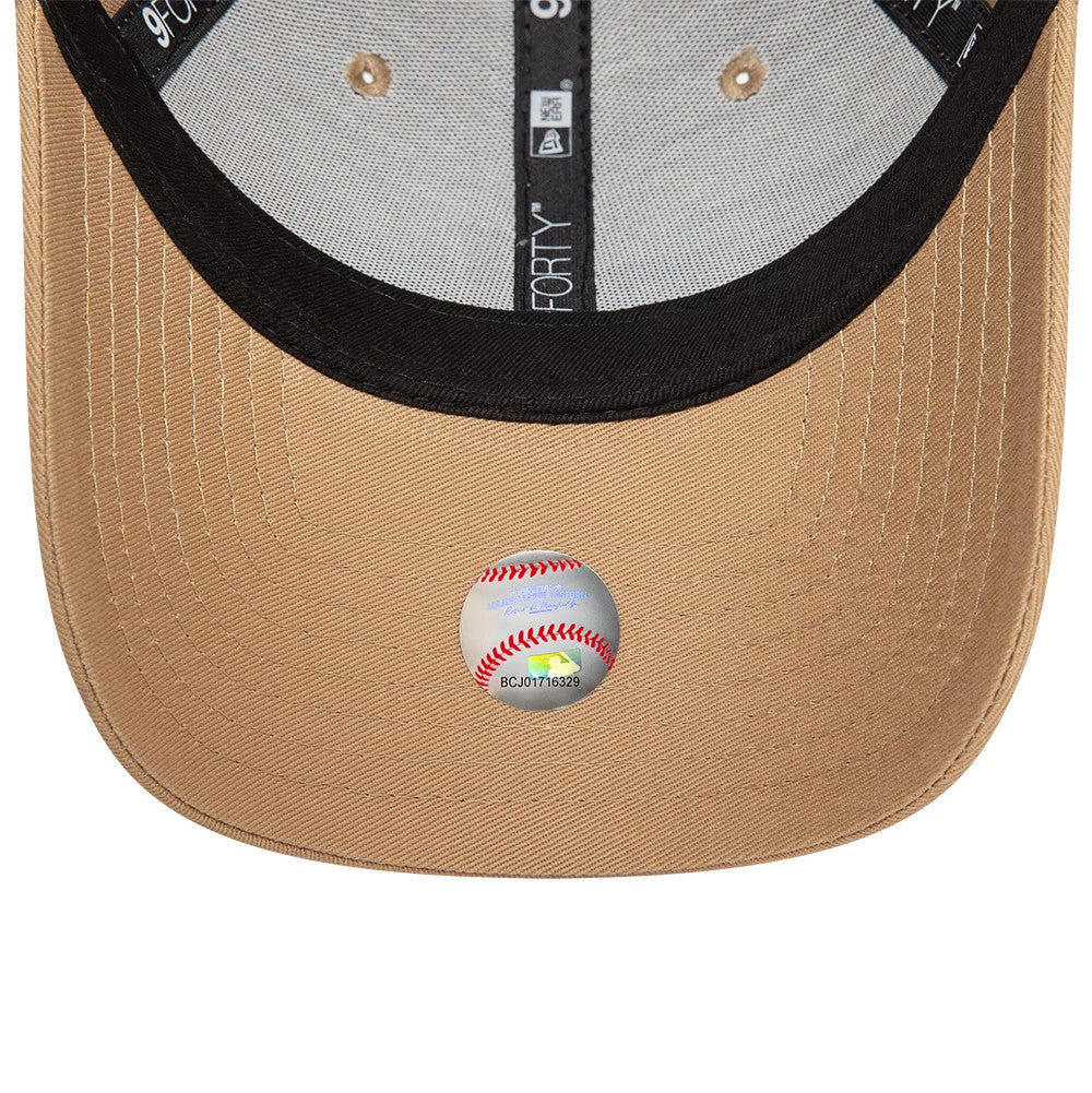 New York Yankees Womens League Essential Beige New Era 9FORTY Adjustable Cap, inside view showing black taping with white 9FORTY branding, beige undervisor, and a holographic sticker of a baseball on the underside.