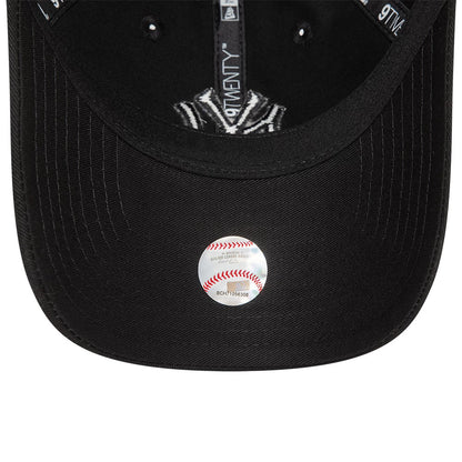 New York Yankees League Essential Black On Black New Era 9TWENTY Adjustable Cap, inside view showing black taping with 9TWENTY branding, a black sweatband, and a transparent sticker on the underside of the visor.
