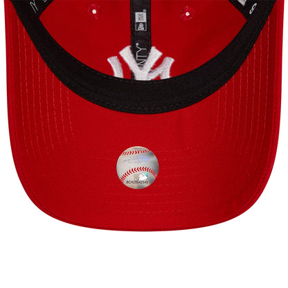 New York Yankees League Essential Red New Era 9TWENTY Adjustable Cap, inside view showing the black taping, New York Yankees logo embroidery on the internal tag, and a baseball-themed sticker on the red undervisor.