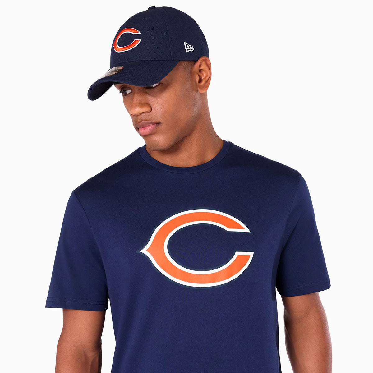 New Era Chicago Bears NFL Navy T-Shirt, on-model view showing large orange outlined 'C' logo on the front, paired with a navy cap featuring a raised 'C' logo on the front and a raised New Era logo on the side.
