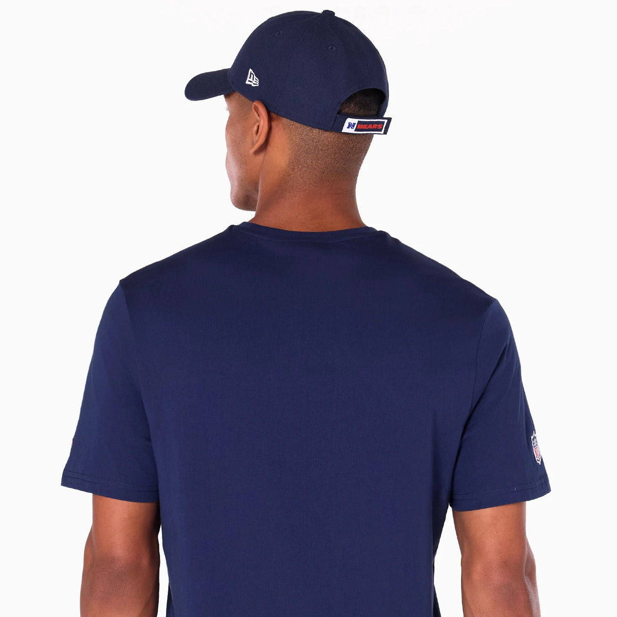 New Era Chicago Bears NFL Navy T-Shirt, rear view featuring the plain navy back, a small logo patch on the left sleeve, and a navy cap with a raised New Era logo on the side above the ear.