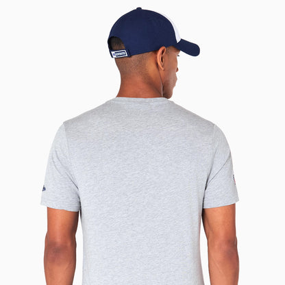 New Era Dallas Cowboys NFL Grey T-Shirt, on-model rear view showing a light grey fabric with short sleeves, paired with a navy and white cap featuring an embroidered Cowboys logo patch at the centre back above the opening.