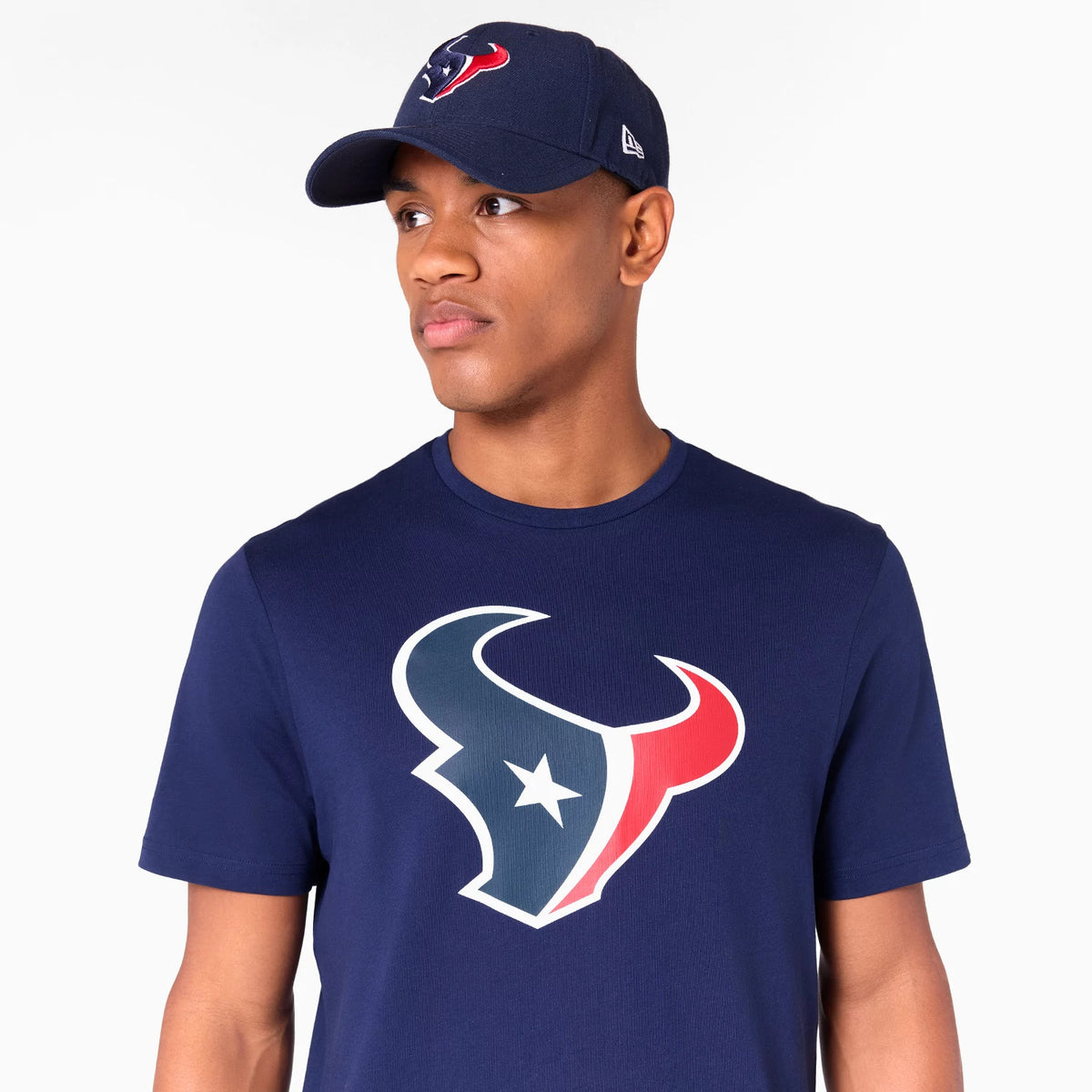 New Era Houston Texans NFL Navy T-Shirt, on-model view showing a large team logo printed on the chest, paired with a navy cap featuring an embroidered team logo on the front and a raised New Era logo on the side.