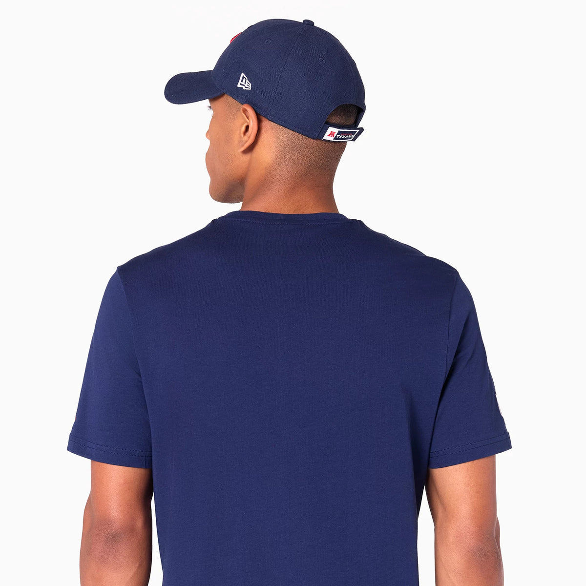 New Era Houston Texans NFL Navy T-Shirt, rear view showing the navy back and short sleeves of the shirt worn by a model, a navy cap on the model's head with a raised New Era logo on the side and eyelets across the top.