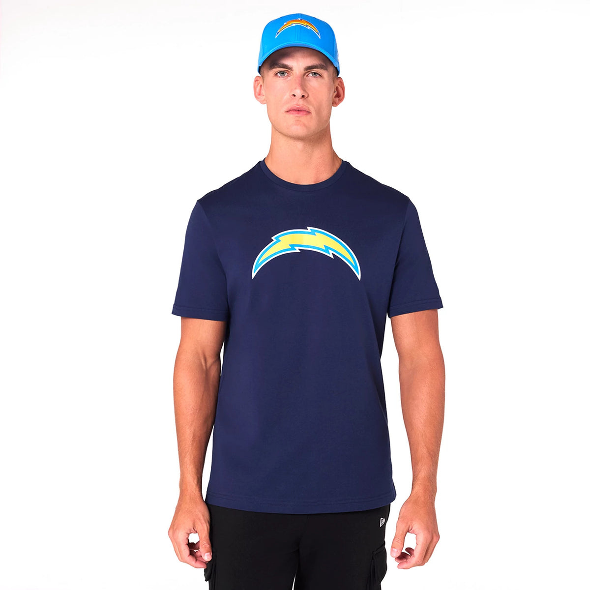New Era LA Chargers NFL Blue T-Shirt, on-model view showing a man wearing a navy blue T-shirt with the LA Chargers bolt logo printed across the chest and a matching blue cap with the same logo on the front.
