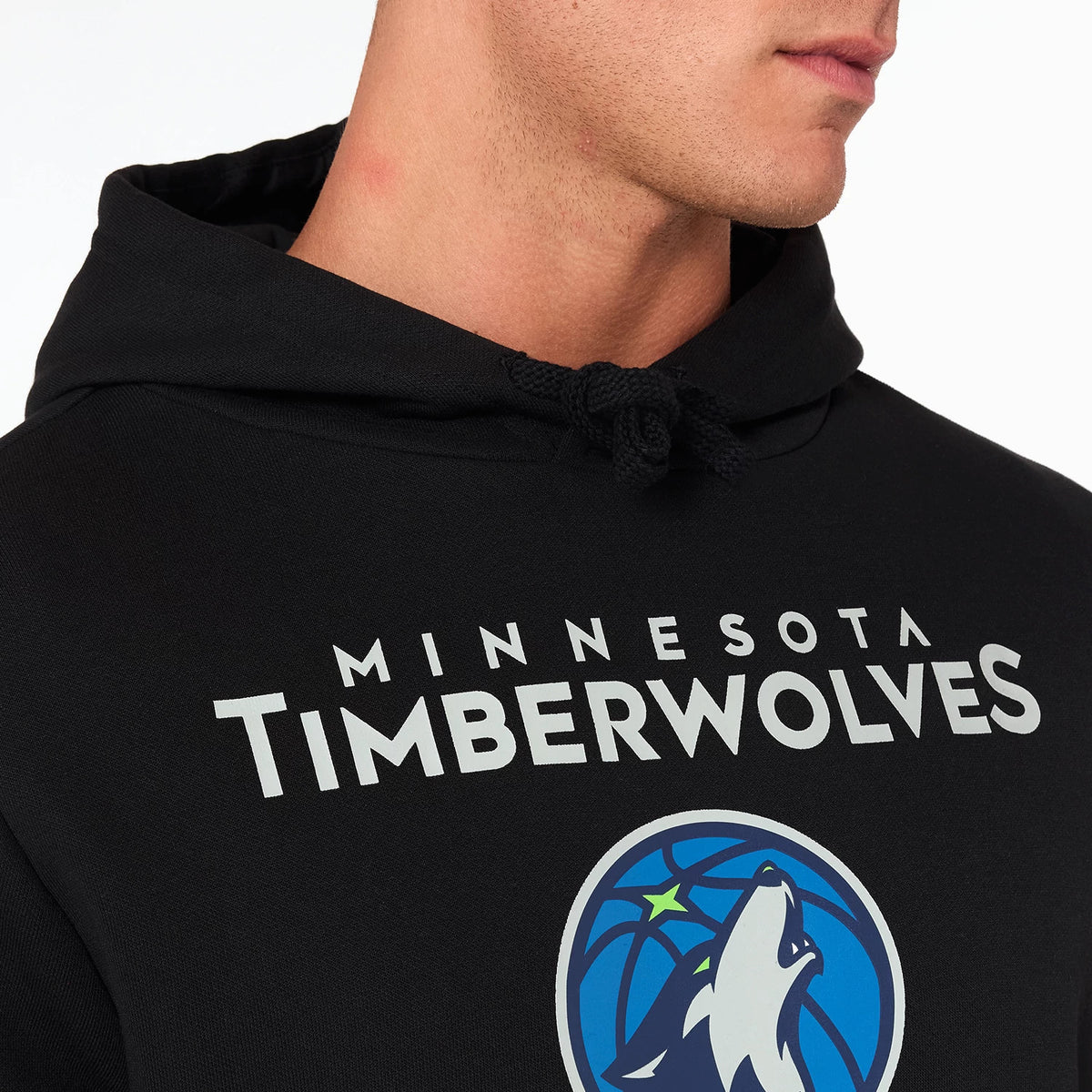 New Era Minnesota Timberwolves NBA Black Pullover Hoodie, front view showing the black fabric with a large printed Timberwolves logo centred on the chest, white MINNESOTA TIMBERWOLVES text above the logo, and a drawstring hood.