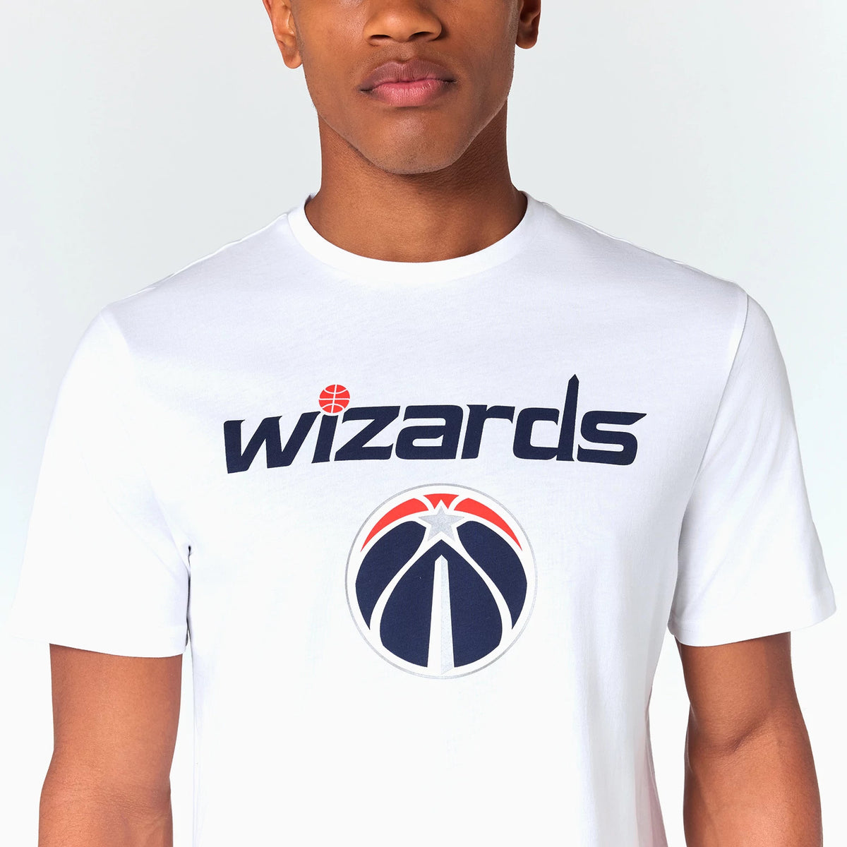 New Era Washington Wizards NBA White T-Shirt, front view showing the navy blue wizards text with a basketball dotting the 'i' and the Washington Wizards logo centred below, both printed on the chest of the white shirt.