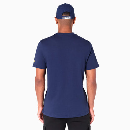 New Era Indiana Pacers NBA Graphic Navy T-Shirt, on-model rear view showing the plain navy fabric, the Pacers logo patch on the left sleeve, and the back of a navy cap with an Indiana Pacers band above the closure.