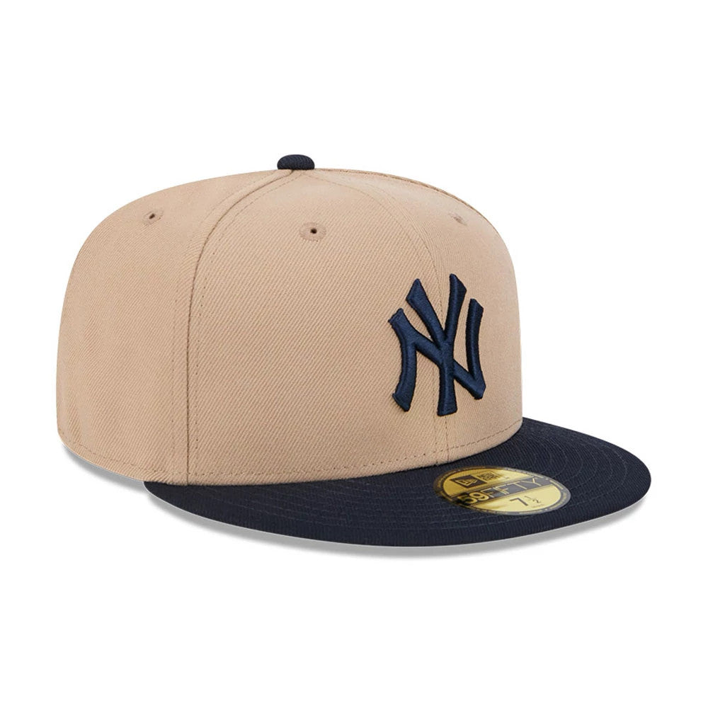 New York Yankees MLB Evergreen Light Beige New Era 59FIFTY Fitted Cap, three-quarter view with a navy embroidered NY logo on the front panel, contrasting navy visor, and gold 59FIFTY size sticker on the visor.