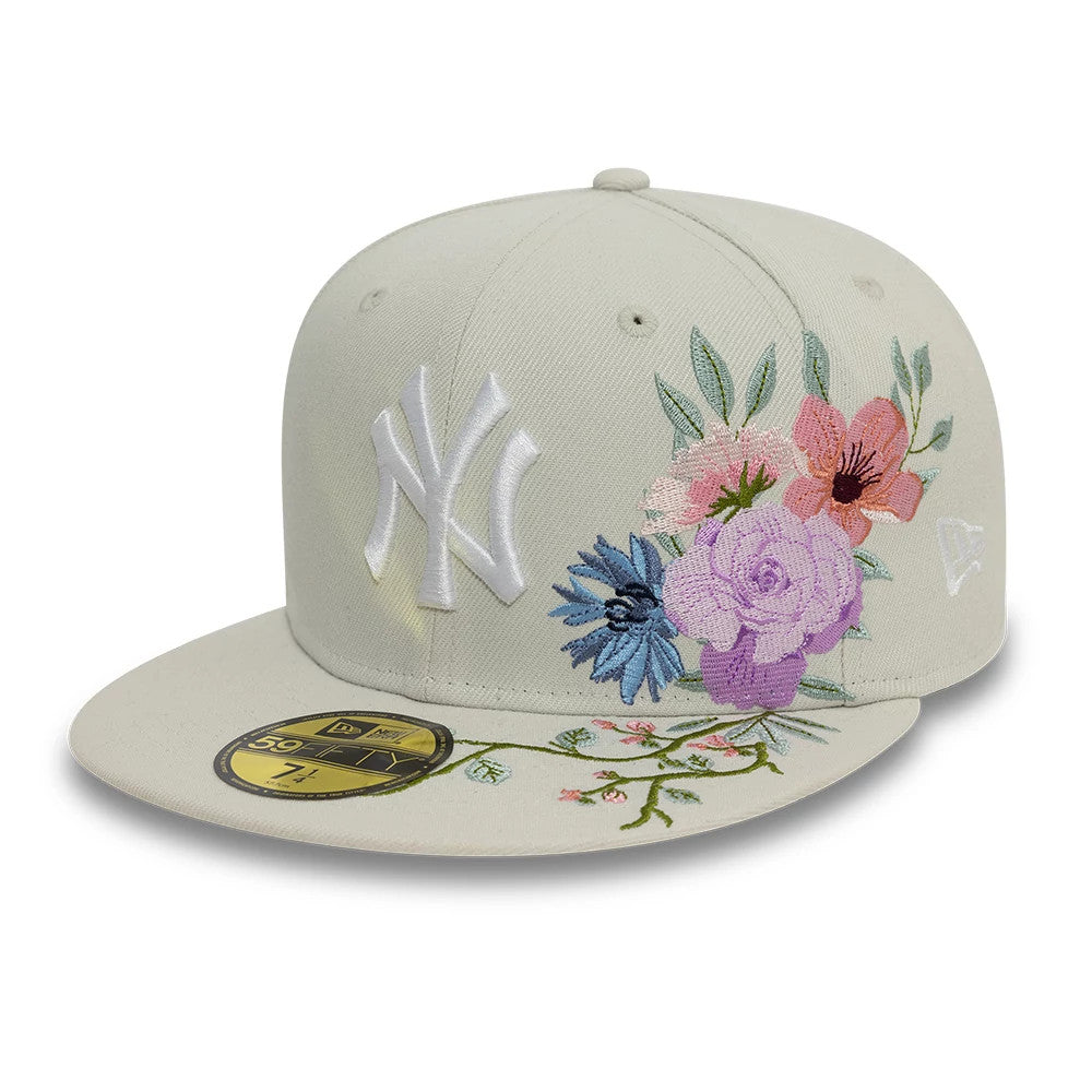 New York Yankees MLB Floral Light Beige New Era 59FIFTY Fitted Cap, front view showing the white embroidered NY logo on the front panel, colourful floral embroidery to the right, and a gold 59FIFTY size sticker on the flat visor.