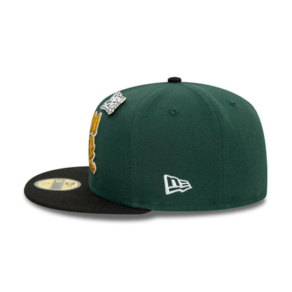 New Era Front Script Dark Green & Black New Era 59FIFTY Fitted Cap, side view showing the white embroidered New Era flag logo on the left side, with a black flat visor and a gold 59FIFTY size sticker on top.
