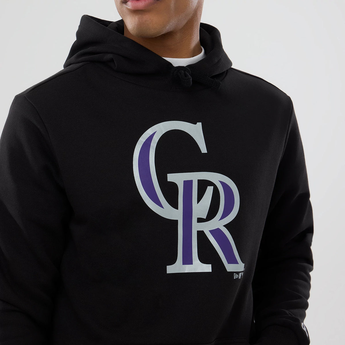 New Era Colorado Rockies MLB Black Pullover Hoodie, front view showing a large grey and purple CR logo centred on the chest, with a drawstring hood and the New Era logo debossed near the hem.