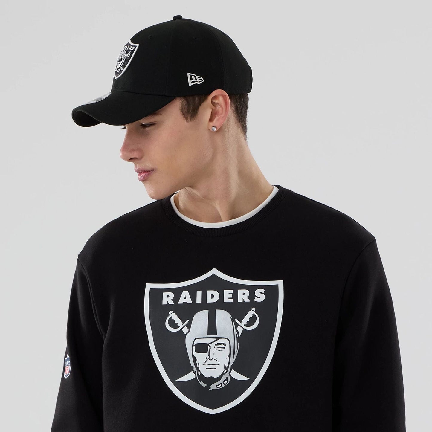 The Male model is wearing Las Vegas Raiders NFL Black Crew Neck Sweater 5
