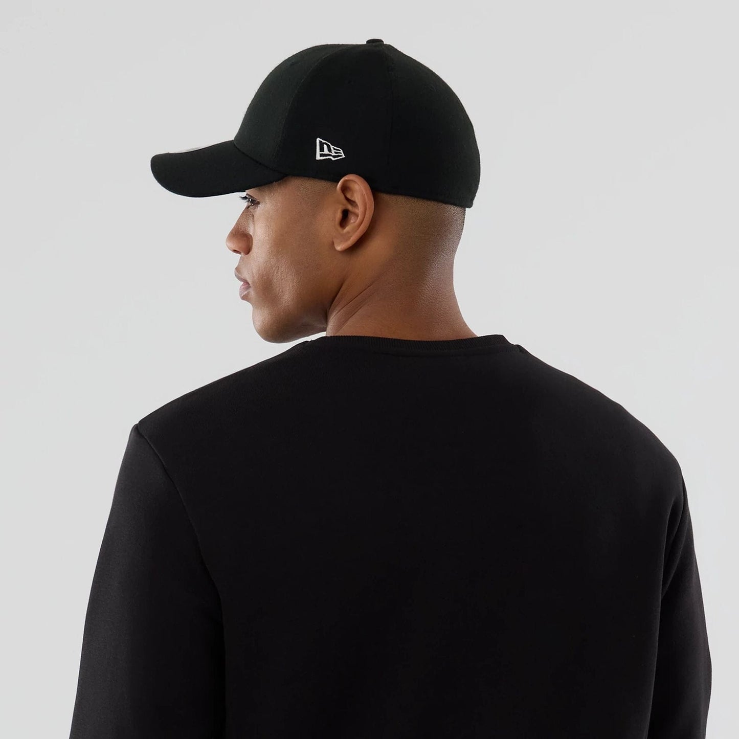 The Male model is wearing NFL Generic Logo Black Crew Neck Sweater 6