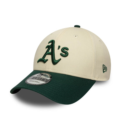 Athletics Colour Block Cream New Era 9FORTY Adjustable Cap, three-quarter view showing raised green A's logo on front panel, dark green visor with a 9FORTY size sticker, and New Era flag logo on the left side.