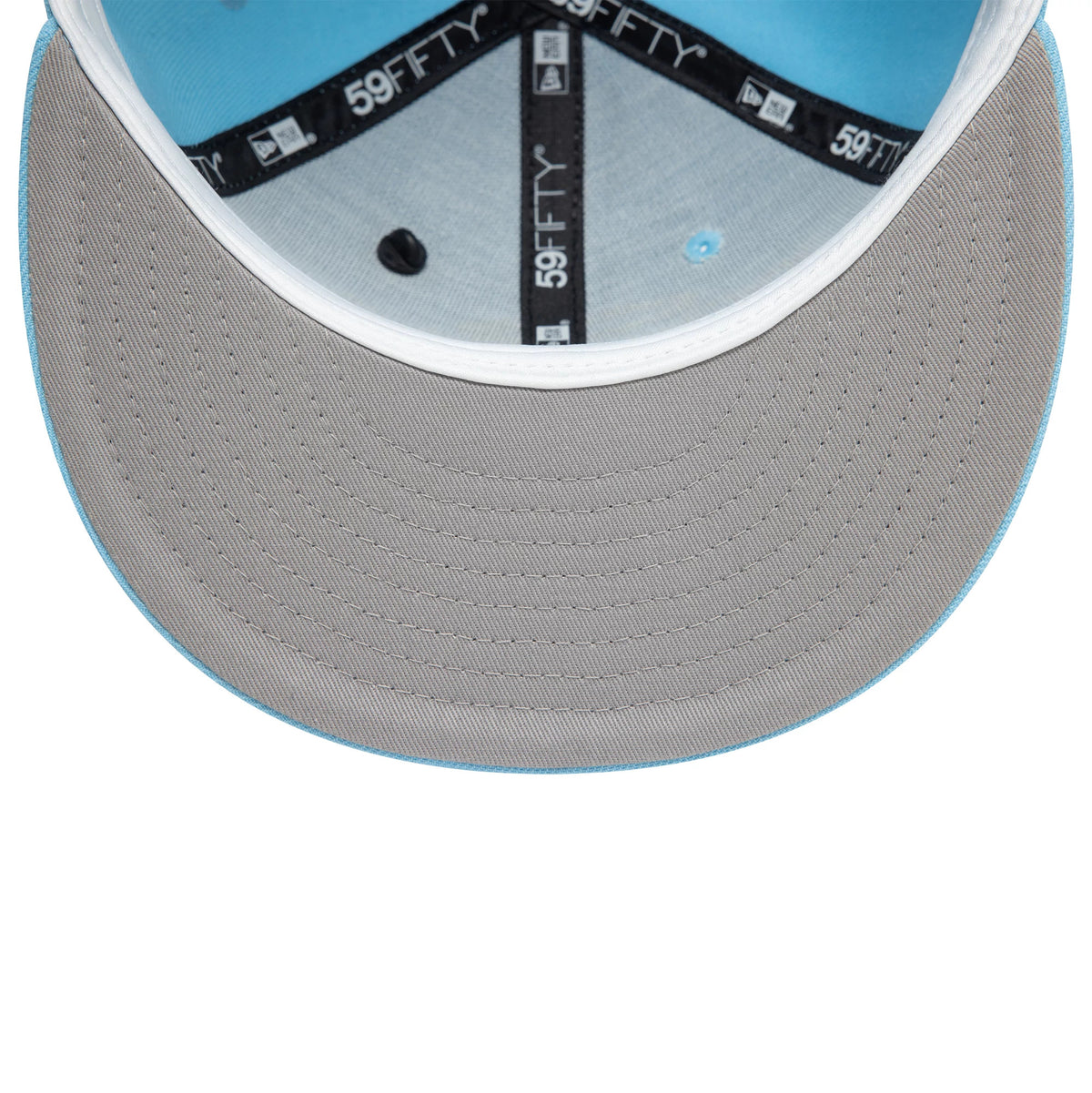 New Era Graphic Pastel Blue New Era 59FIFTY Fitted Cap, inside view showing grey undervisor, black taping with 59FIFTY branding, and a light blue sweatband beneath the structured crown.
